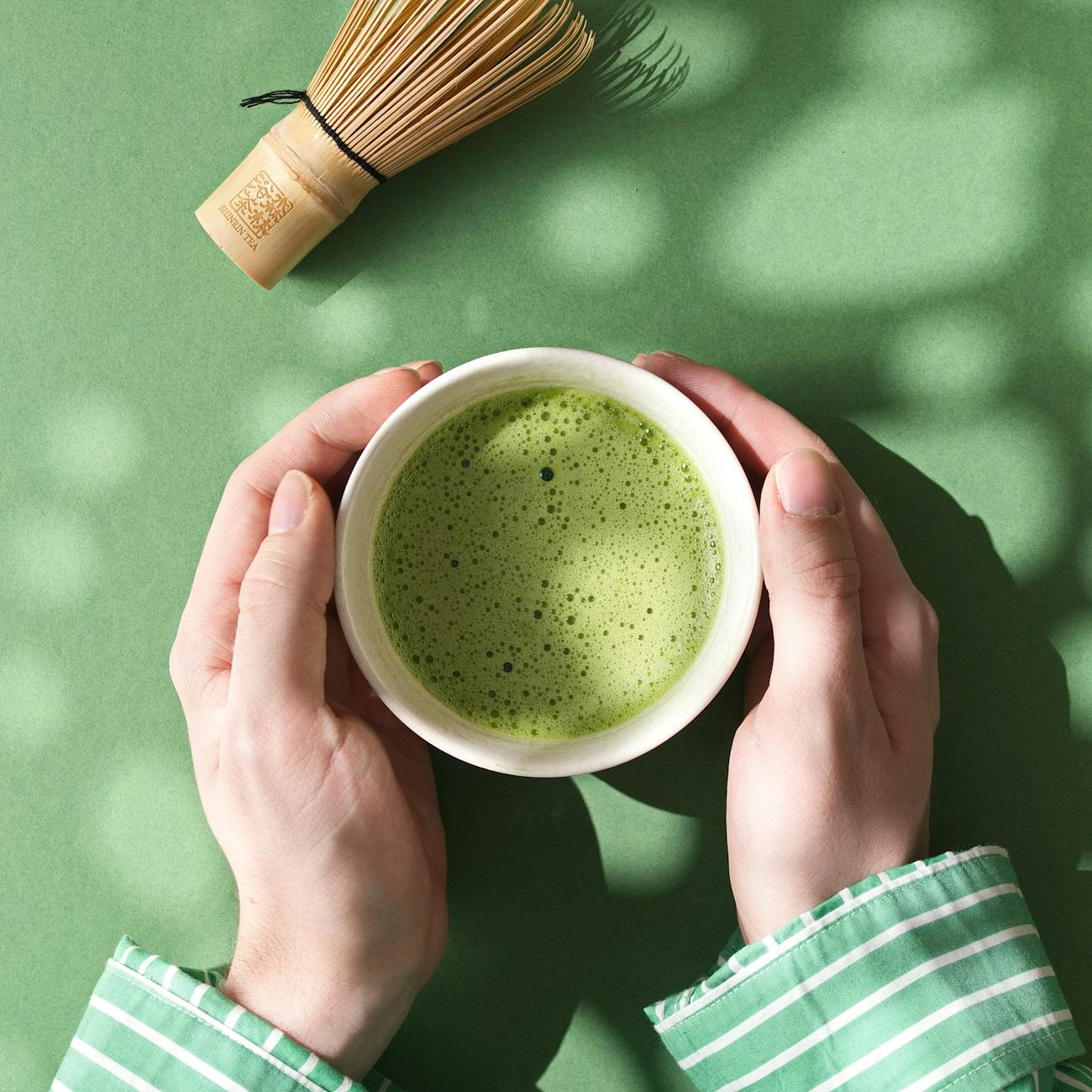 hands holding a matcha cup